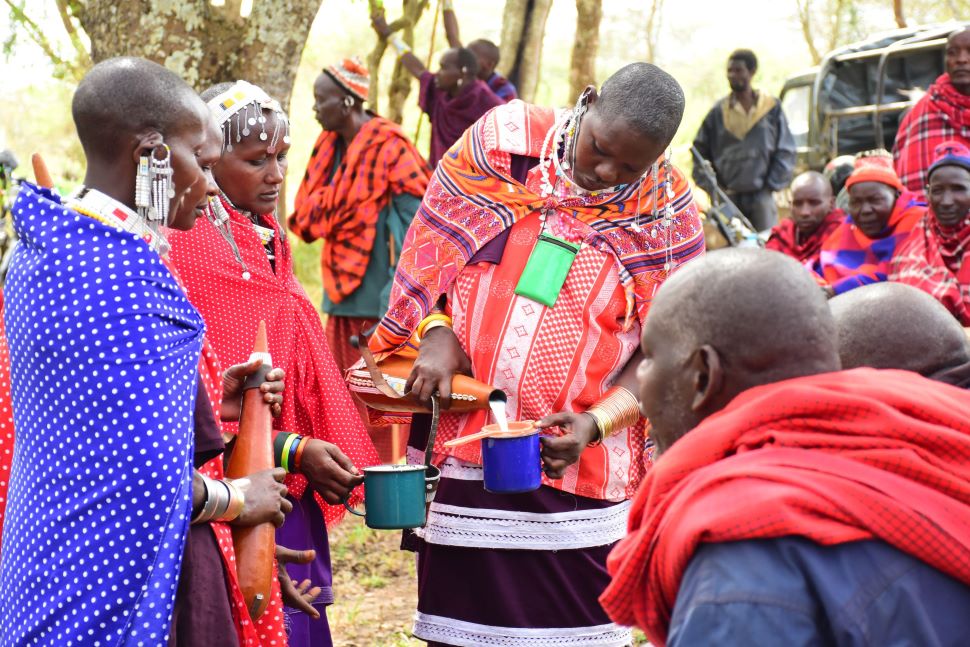 a female farmer in kiteto district shares milk from livestock with fellow community me 2560x1707